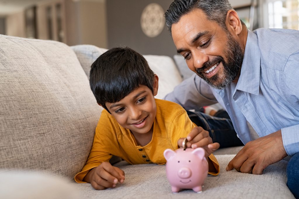 father and child with a piggy bank